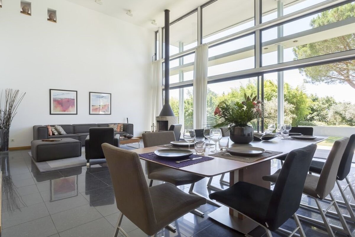 A dining room table with plates and glasses on it