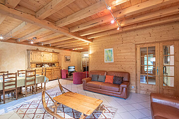 A living room with a couch a table and chairs