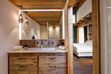 A bathroom with wooden cabinets and a sink