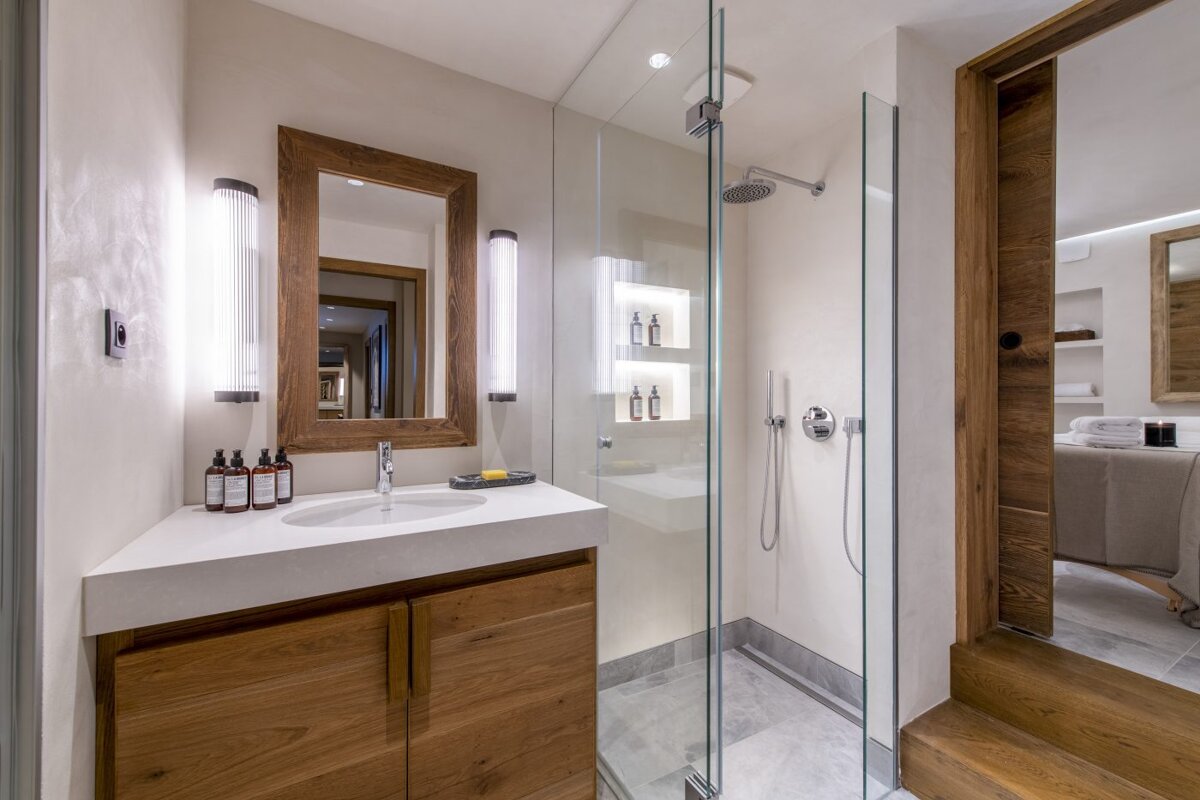 A bathroom with a sink and a walk in shower