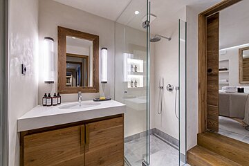 A bathroom with a sink and a walk in shower