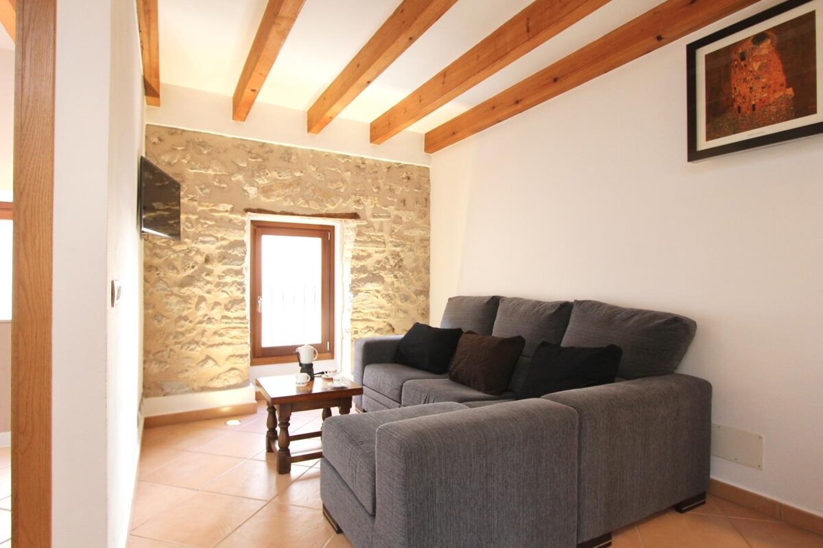 A living room with a couch and a picture on the wall