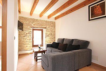 A living room with a couch and a picture on the wall
