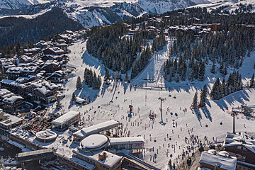An aerial view of a ski resort with skiers on the slopes