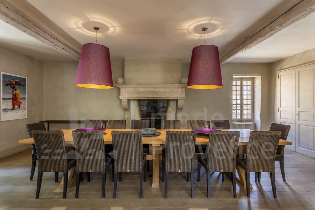 A dining room with a table and chairs and a sign that says provence