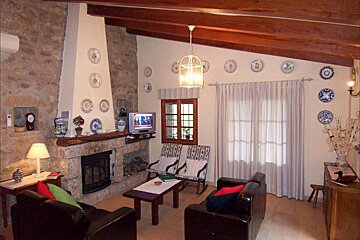 A living room with a fireplace and plates on the wall