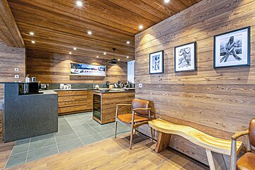 A kitchen with wooden walls and a picture on the wall that says ' hawaii '