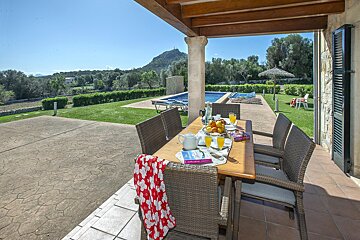 A table with a book on it sits on a patio
