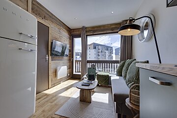 A room with a smeg refrigerator and a couch