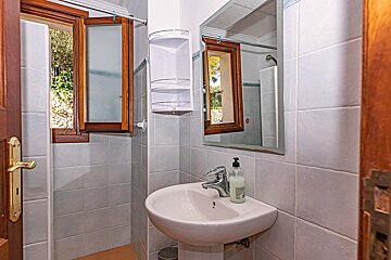 A bathroom with a sink a mirror and a window