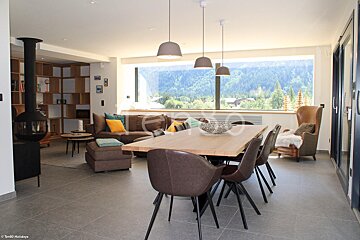 A living room with a large table and chairs