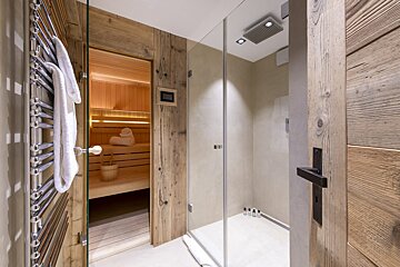 A bathroom with a sauna and a walk in shower