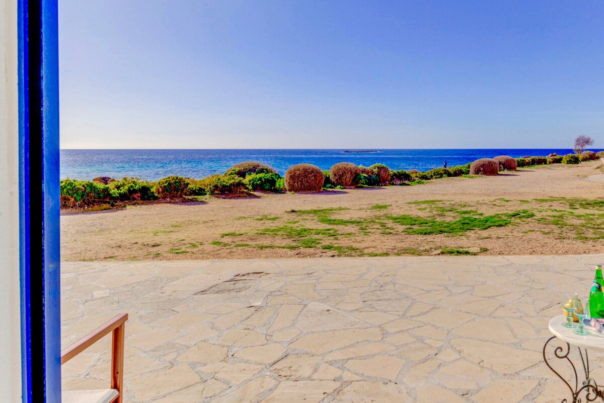 A view of the ocean from a stone patio