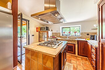 A kitchen with a stove top oven and a lg refrigerator