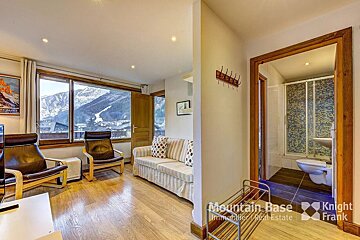 A living room with a couch and chairs and a sign that says mountain base