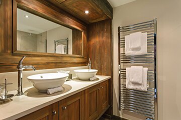 A bathroom with two sinks and a towel rack