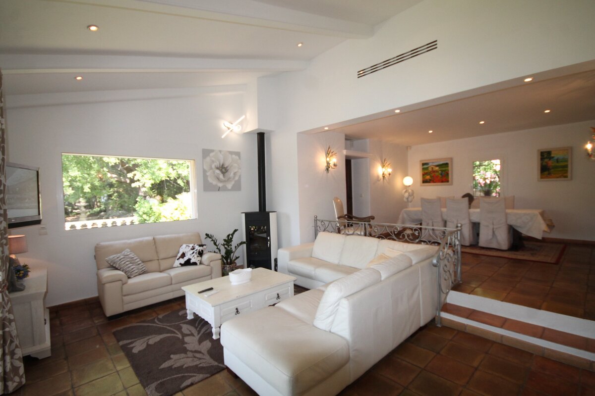 A living room with two white couches and a white coffee table
