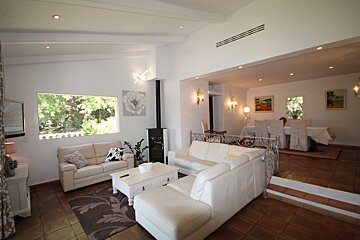 A living room with two white couches and a white coffee table