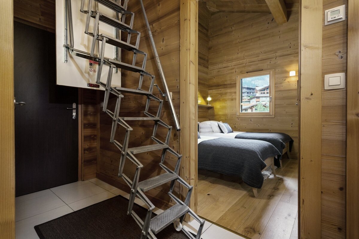 A ladder leading up to a bedroom with two beds