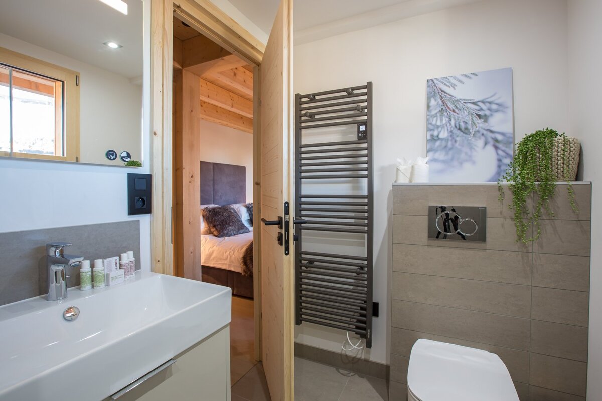 A bathroom with a towel rack and a toilet