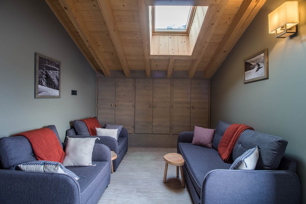 A living room with two couches and a skylight
