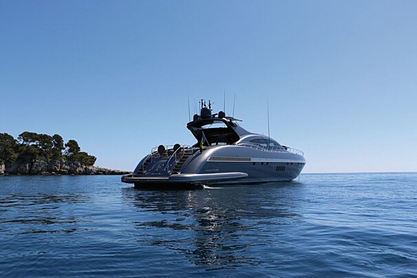A large yacht is floating on top of a body of water