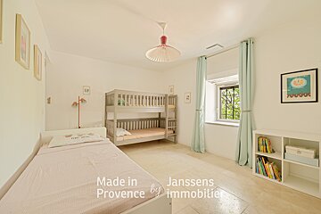 A bedroom with two bunk beds and the words made in provence on the bottom