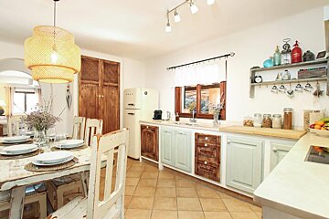 A kitchen with white cabinets and a smeg refrigerator