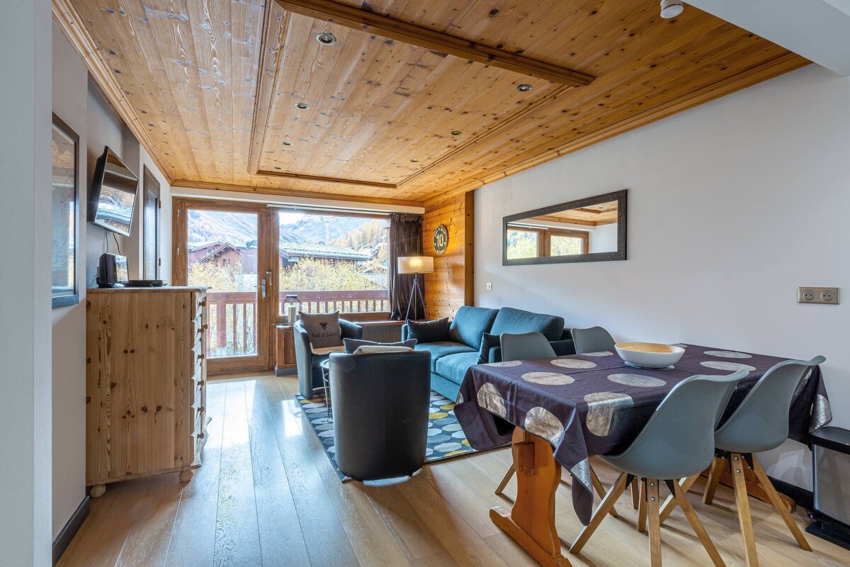 A living room with a table and chairs and a couch