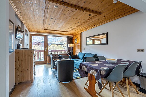A living room with a table and chairs and a couch
