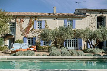 A large house with a swimming pool in front of it