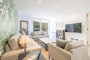 A living room with two couches and a flat screen tv