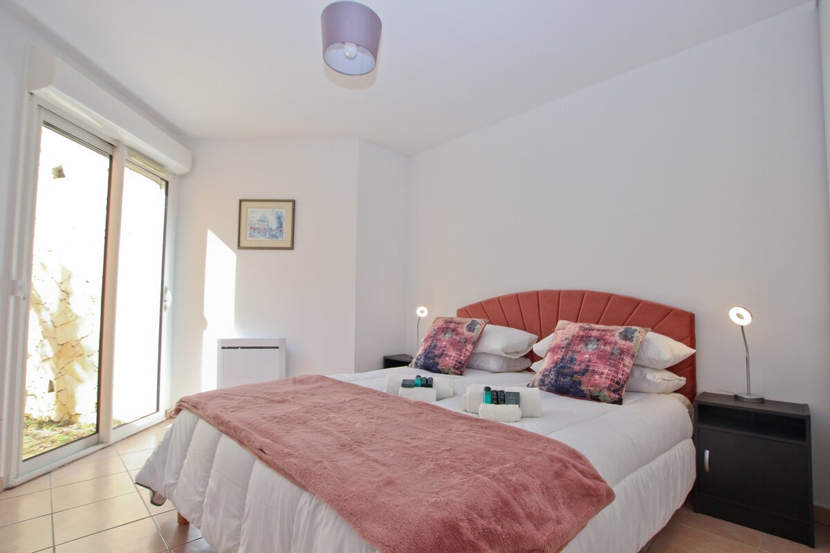 A bedroom with a bed and a picture on the wall