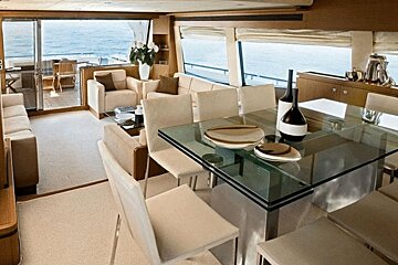 A dining room with a glass table and chairs