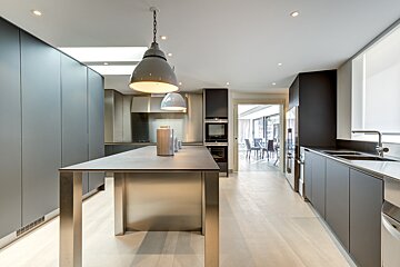 A kitchen with stainless steel cabinets and a large island