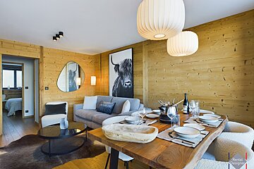 A framed one dollar bill hangs above a dining table