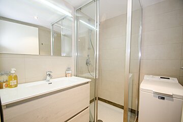 A bathroom with a sink and a washer and dryer