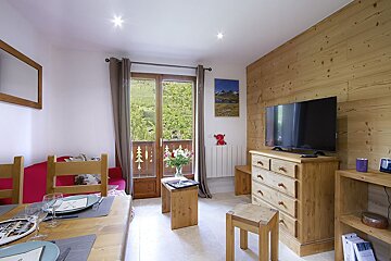 A living room with a dresser and a flat screen tv