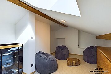 A room with bean bag chairs and a white management logo