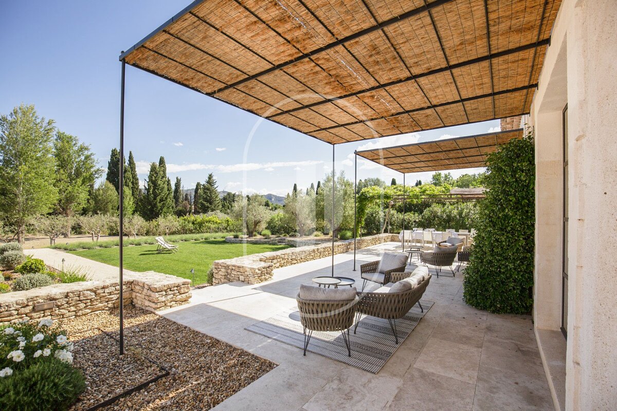 A patio with chairs and tables under a canopy