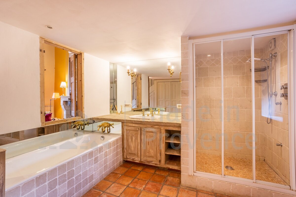 A bathroom with a bathtub a sink and a walk in shower