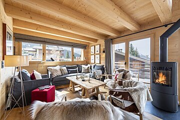 A living room with a couch and chairs and a fireplace