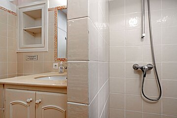 A bathroom with a sign on the wall that says 