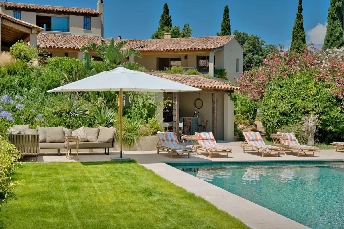 A large house with a swimming pool in front of it