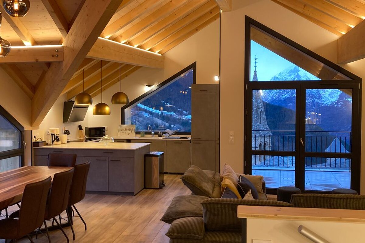 A kitchen and dining area with a view of the mountains