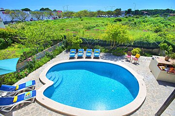 A swimming pool with chairs around it and a sign that says no diving