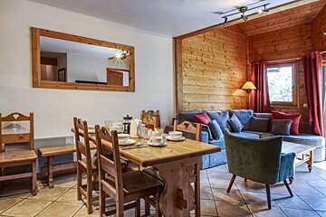 A living room with a dining table and chairs