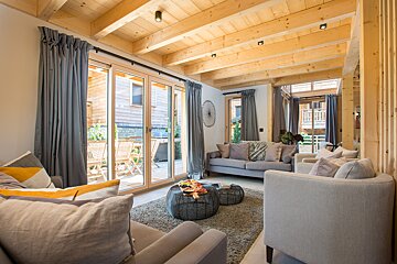 A living room with a couch and two chairs