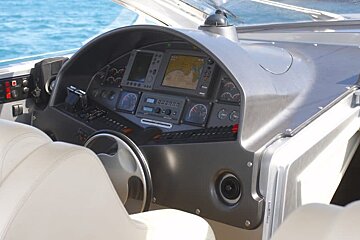 The dashboard of a boat has a gps on it