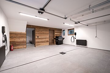 An empty garage with a grill and a fire extinguisher